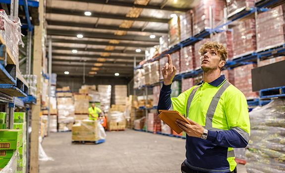 warehouse in Sydney, male employees are focused on inventory management